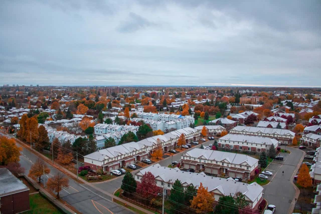 Autumn aerial view of a Brampton townhouse subdivision with tree-lined streets - ADU builders serving Brampton, Ontario, Canada