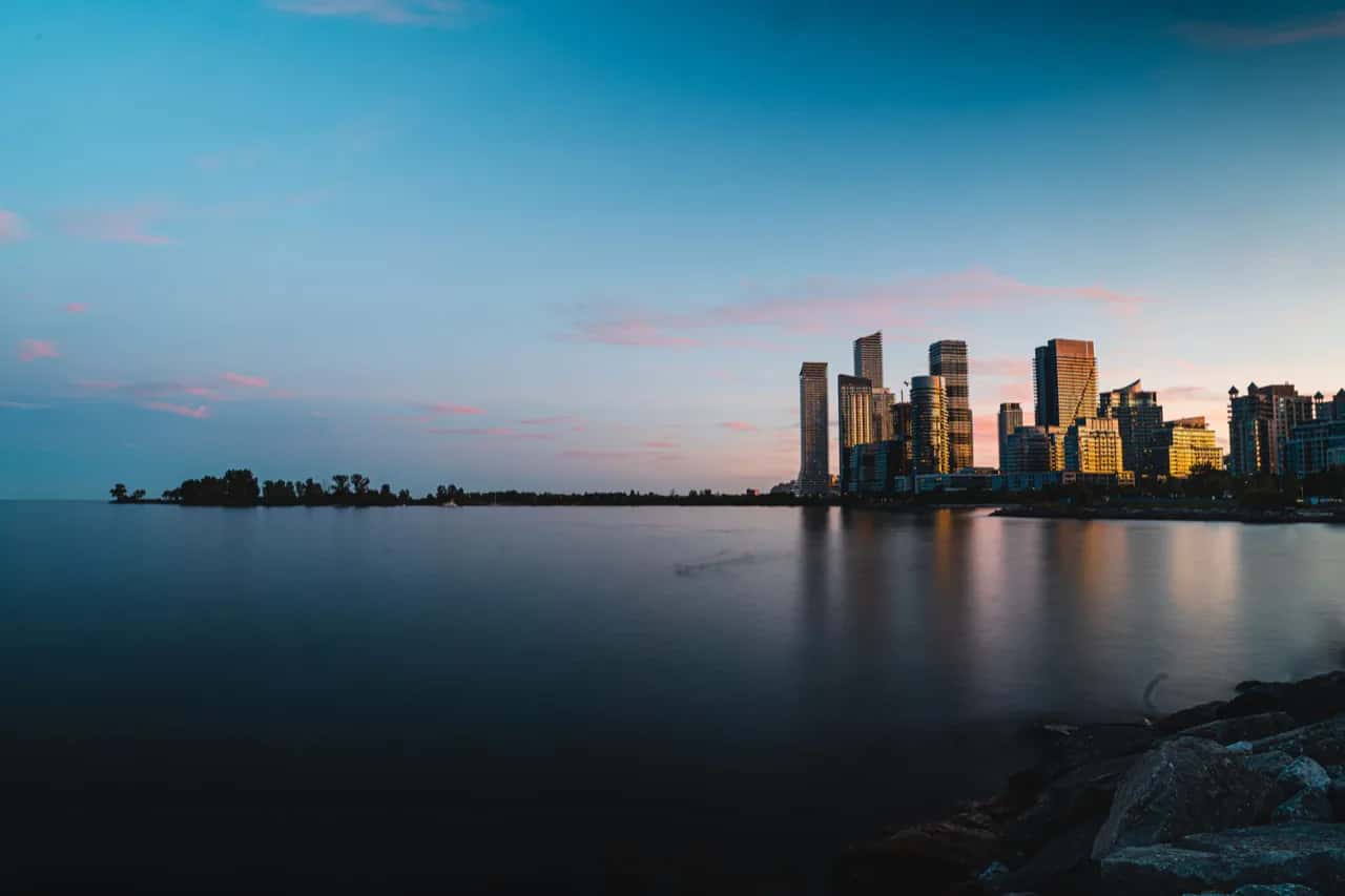 The Humber Bay Shores condo towers of Etobicoke at dusk seen across Lake Ontario - ADU builders serving Etobicoke, Ontario, Canada