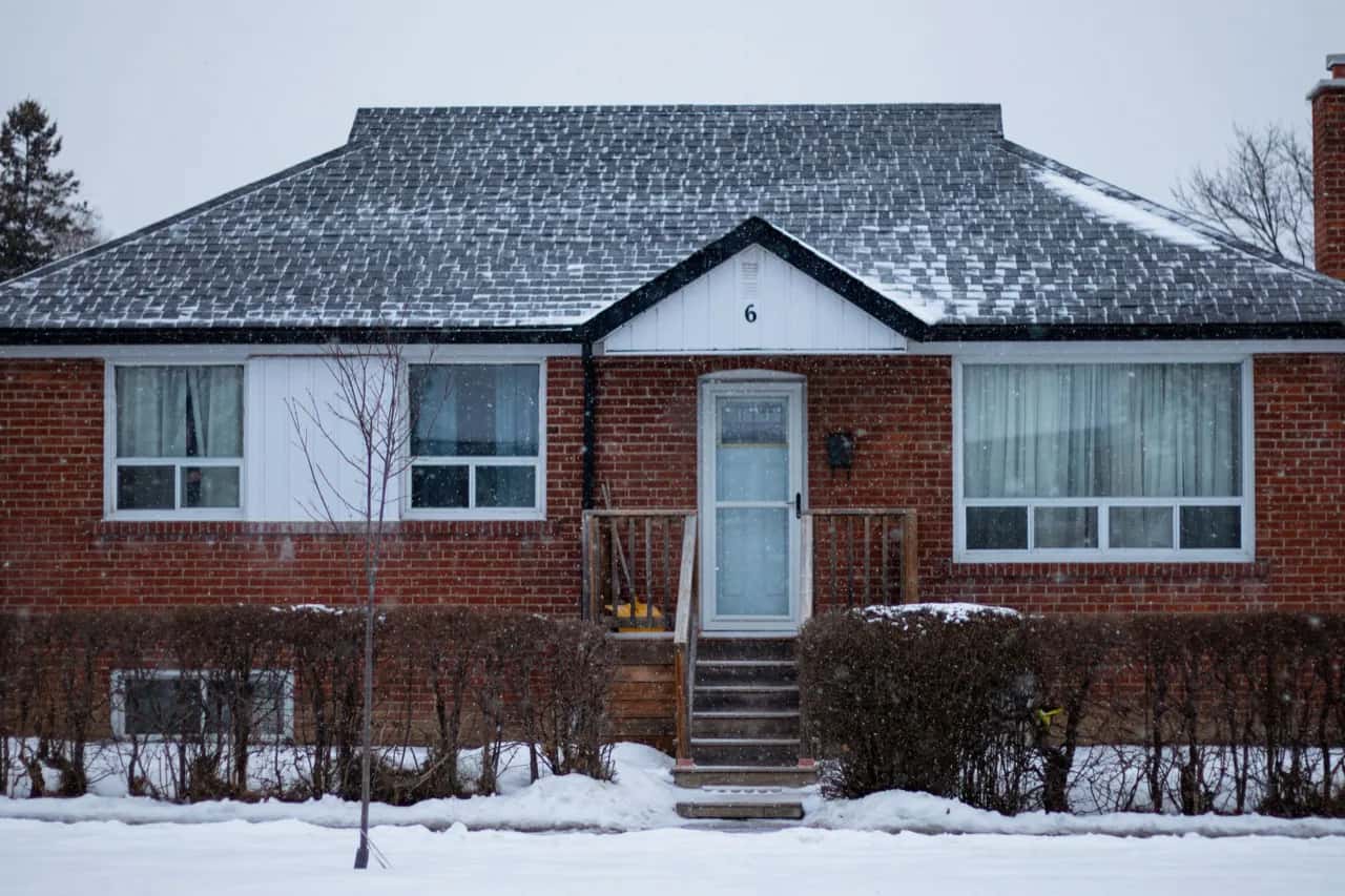 A classic red-brick North York bungalow in winter, the housing stock behind most ADU projects - ADU builders serving North York, Ontario, Canada