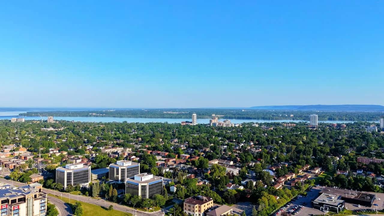 Summer aerial view of a leafy Richmond Hill residential neighbourhood with a lake on the horizon - ADU builders serving Richmond Hill, Ontario, Canada