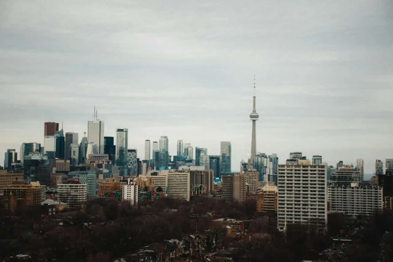 Toronto skyline with the CN Tower and Rogers Centre seen across the lake - ADU builders serving Toronto, Ontario, Canada