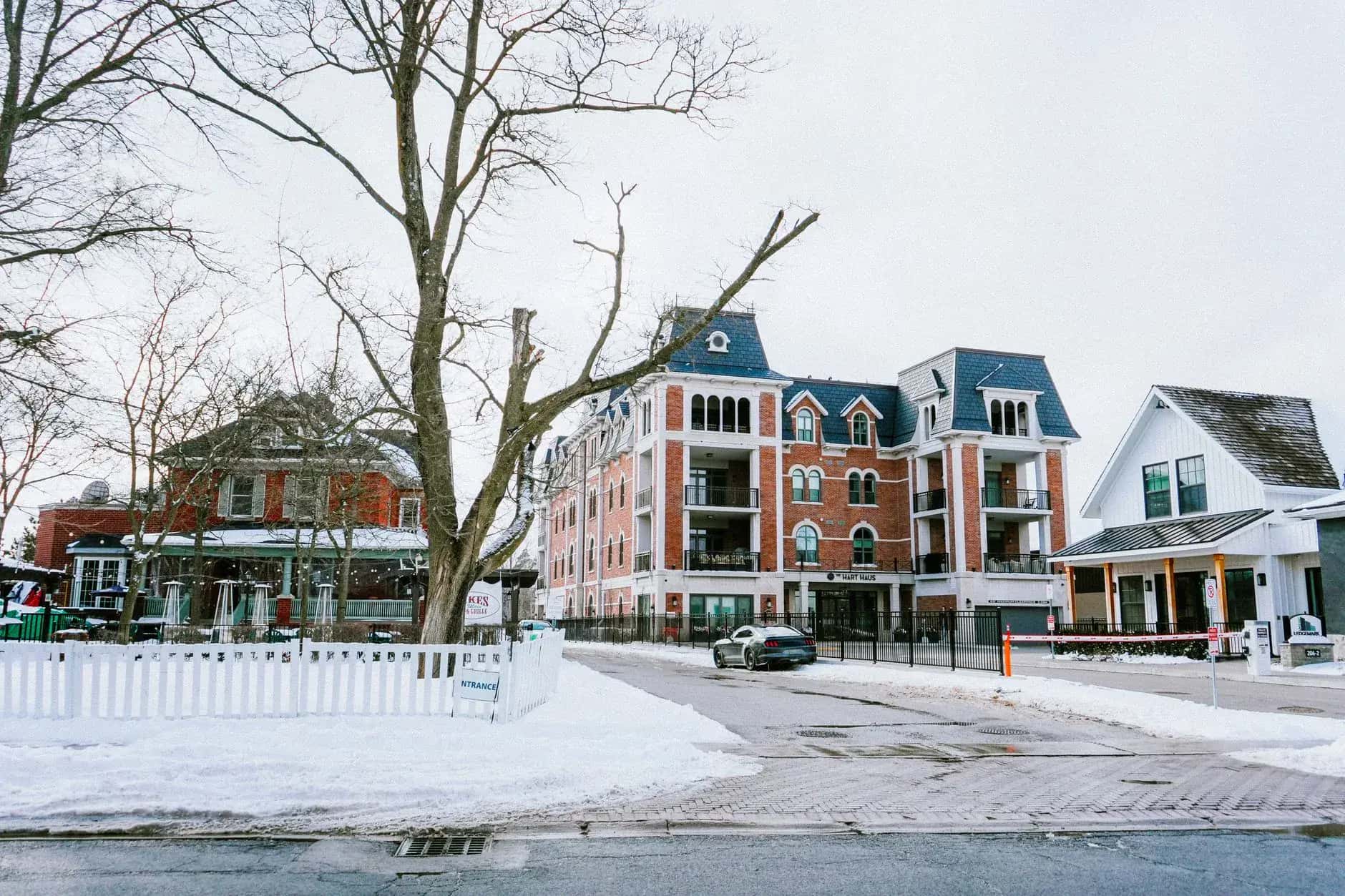 A snowy streetscape mixing older brick buildings with new low-rise construction - ADU builders serving Whitchurch-Stouffville, Ontario, Canada