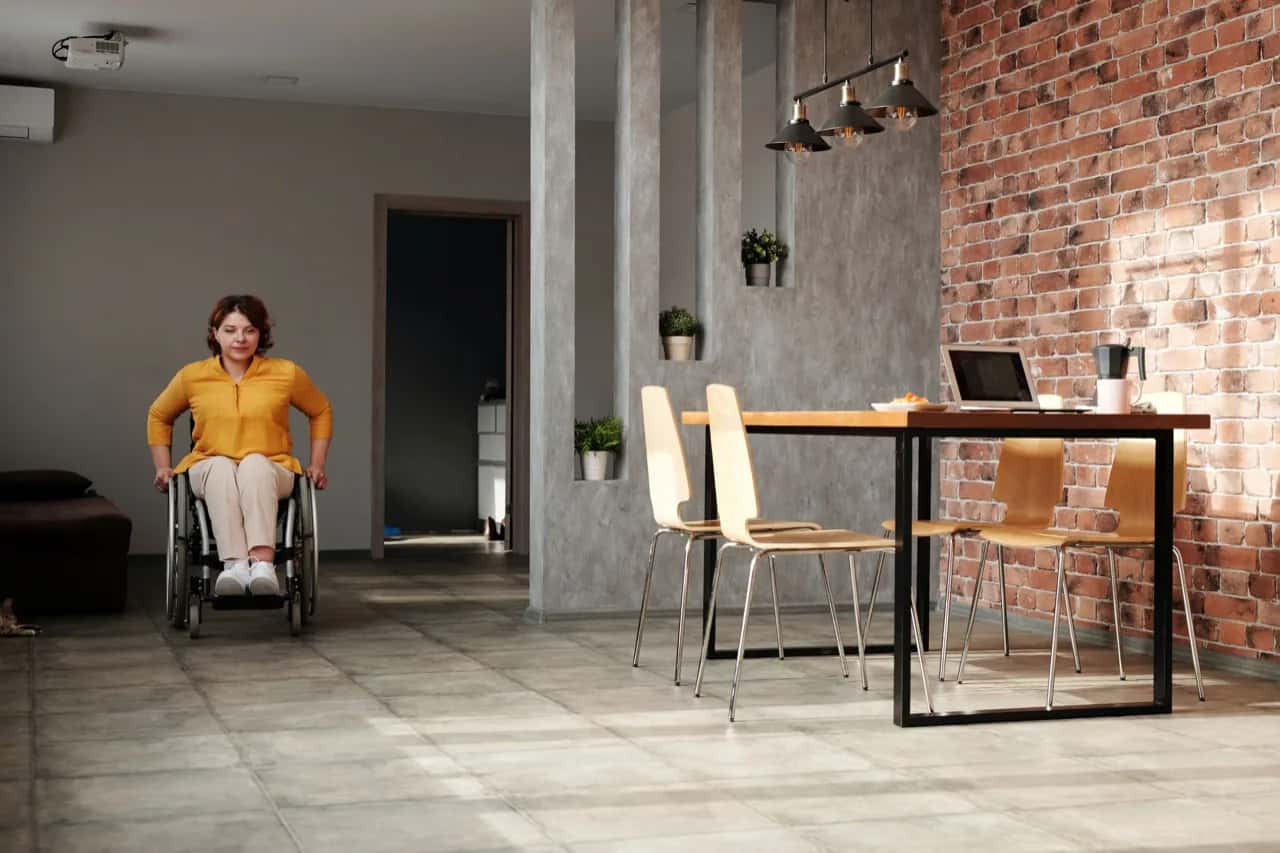 A wheelchair user moving freely through an open barrier-free suite interior - accessible ADU design, Ontario, Canada