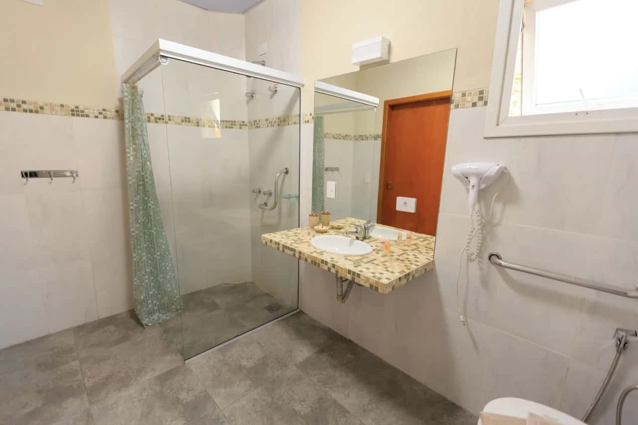Barrier-free bathroom with a curbless walk-in shower and wall-mounted grab bar - aging-in-place ADU design, Ontario, Canada