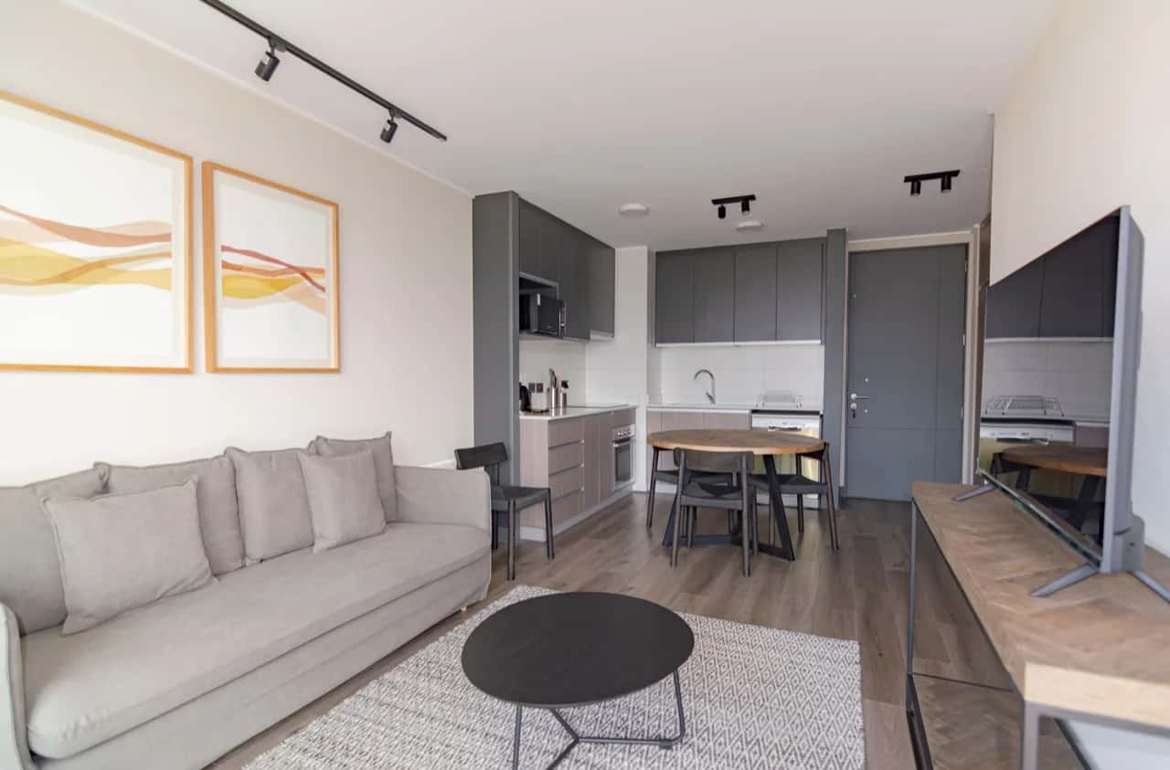 Compact open-plan rental suite interior - sofa, kitchenette and dining nook - rental suite builders, Ontario, Canada