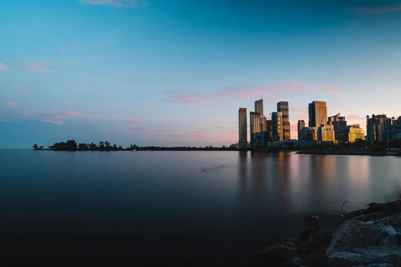 The Humber Bay Shores condo towers of Etobicoke at dusk seen across Lake Ontario - ADU builders serving Etobicoke, Ontario, Canada
