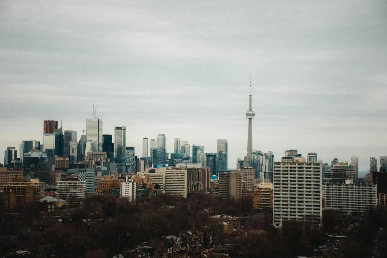 Toronto skyline with the CN Tower and Rogers Centre seen across the lake - ADU builders serving Toronto, Ontario, Canada