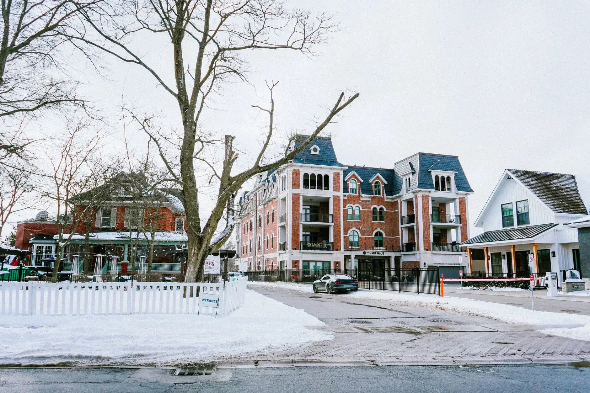 A snowy streetscape mixing older brick buildings with new low-rise construction - ADU builders serving Whitchurch-Stouffville, Ontario, Canada