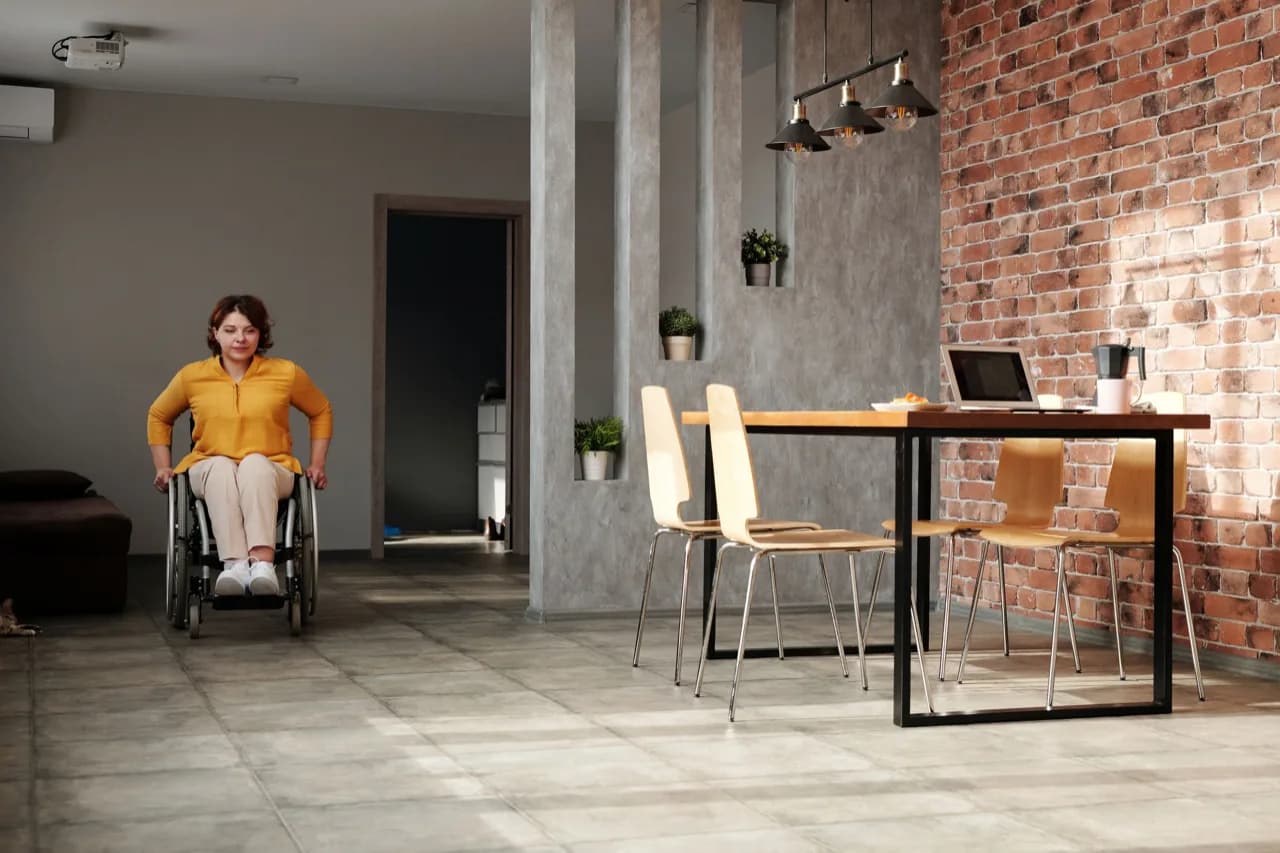 A wheelchair user moving freely through an open barrier-free suite interior - accessible ADU design, Ontario, Canada