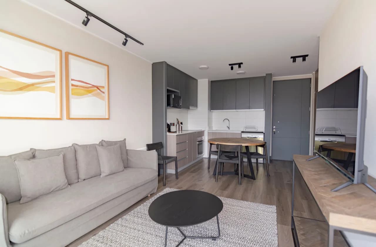 Compact open-plan rental suite interior - sofa, kitchenette and dining nook - rental suite builders, Ontario, Canada