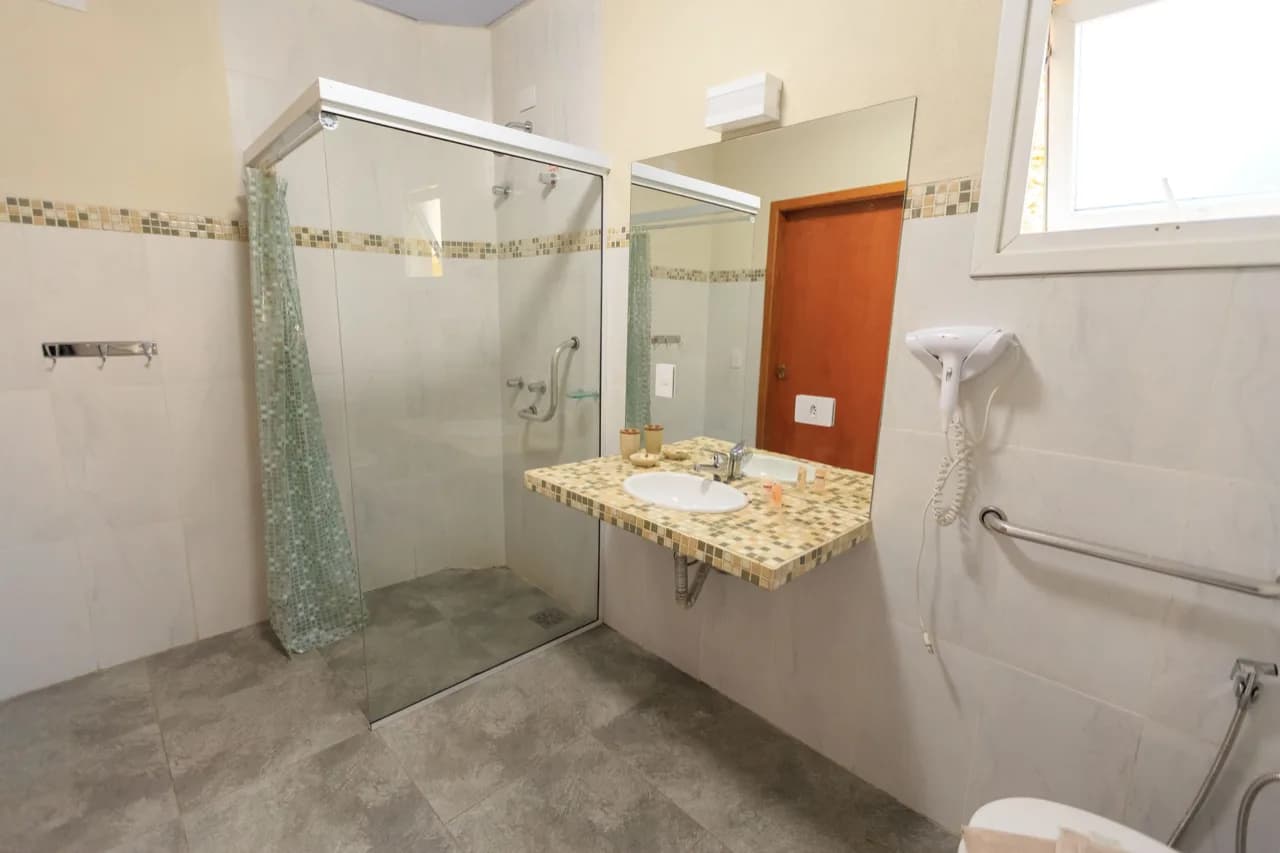 Barrier-free bathroom with a curbless walk-in shower and wall-mounted grab bar - aging-in-place ADU design, Ontario, Canada